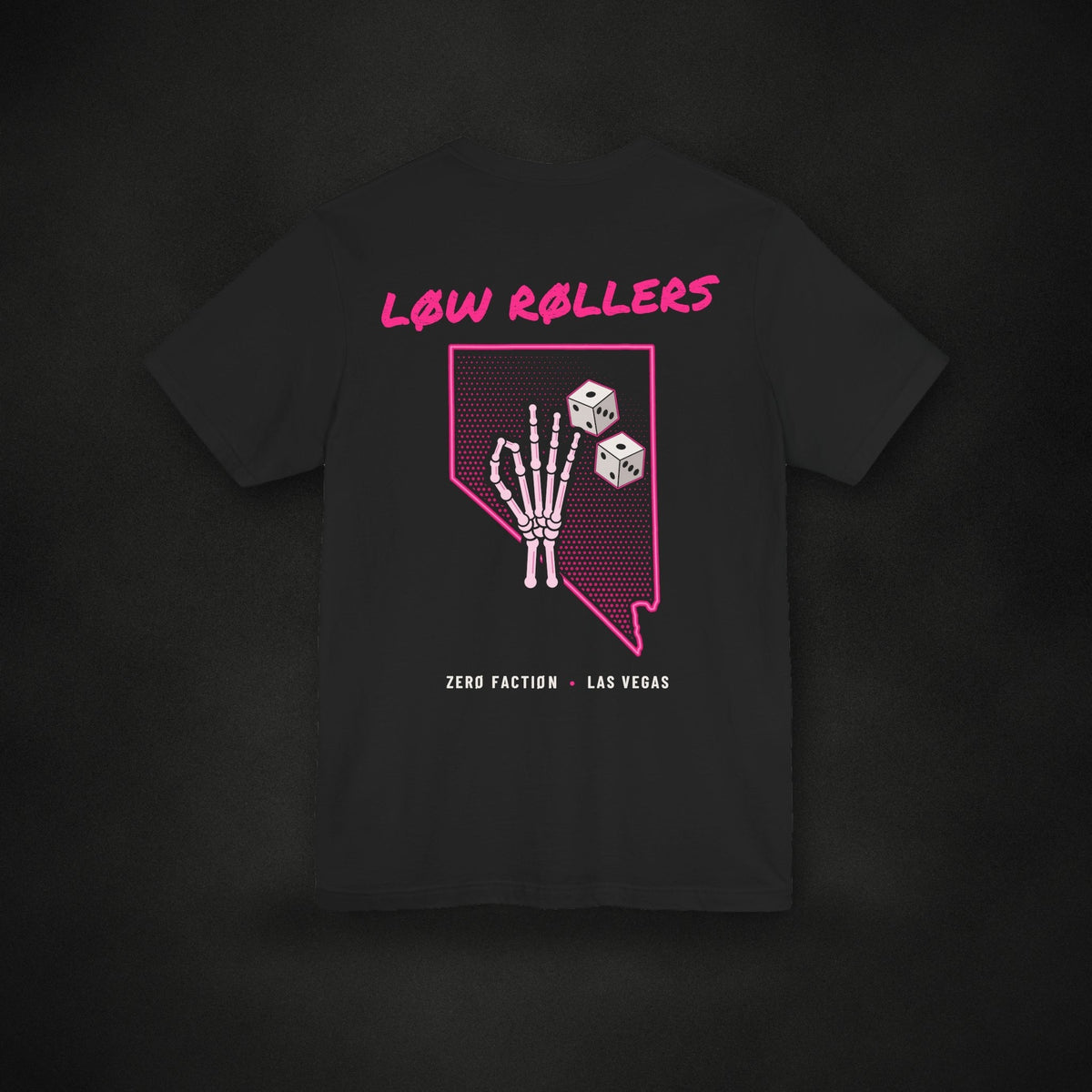 Zero Faction Low Rollers Nevada tee, black, back view, Nevada skeleton hand and dice print, on dark asphalt backdrop
