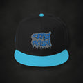 Zero Faction Teal Graffiti Snapback Hat, on dark asphalt backdrop