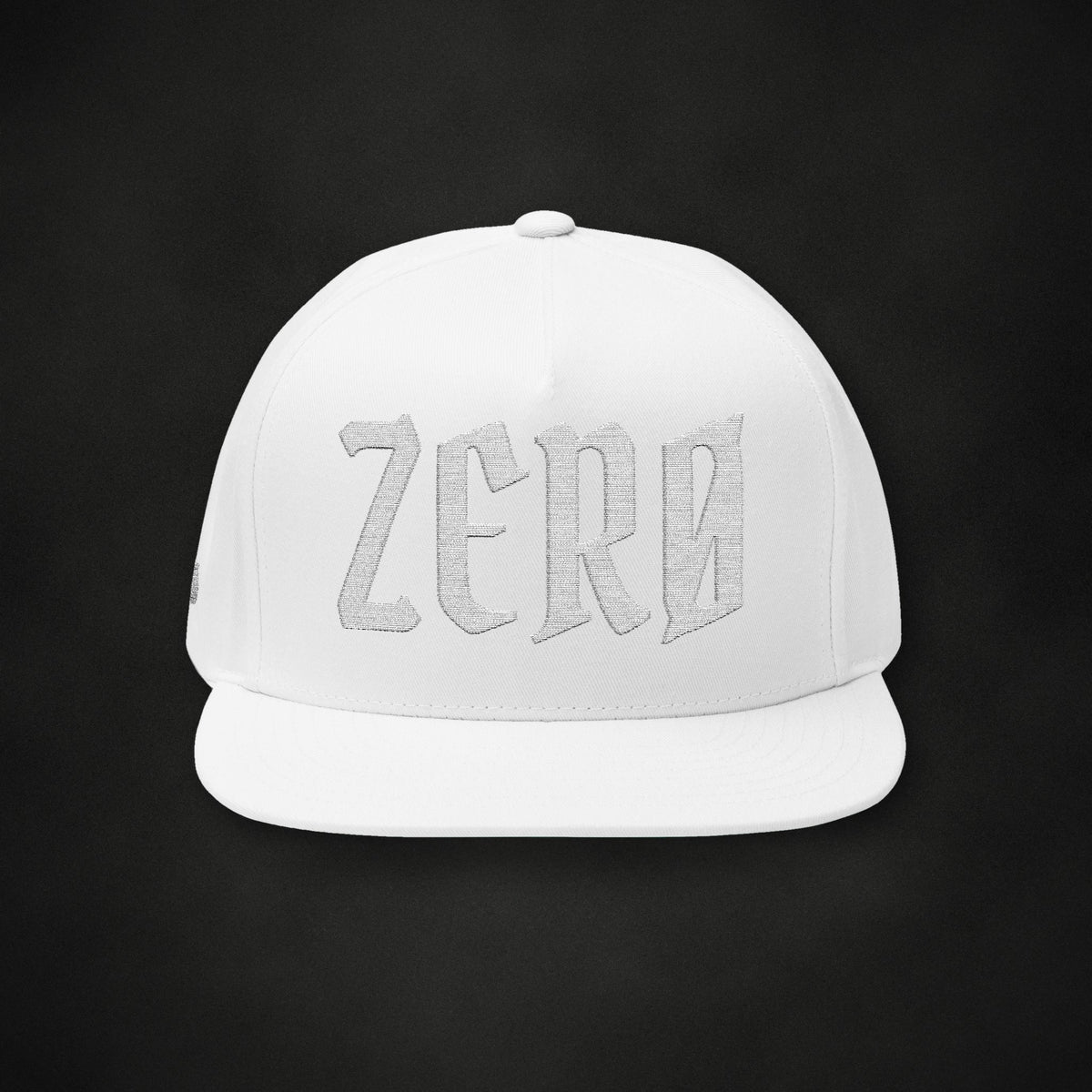 Zero Faction Zero embroidered flat bill snapback hat, white, on dark asphalt backdrop